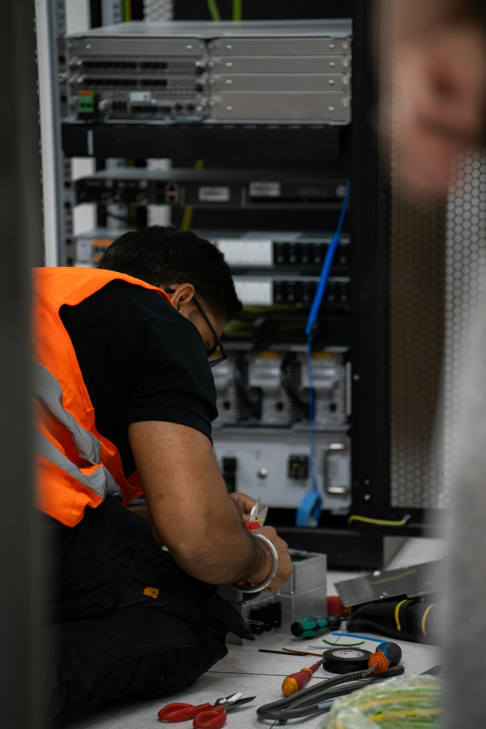 Technician working on server rack equipment