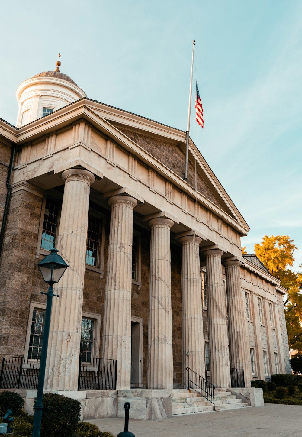 Government building with columns and a flag