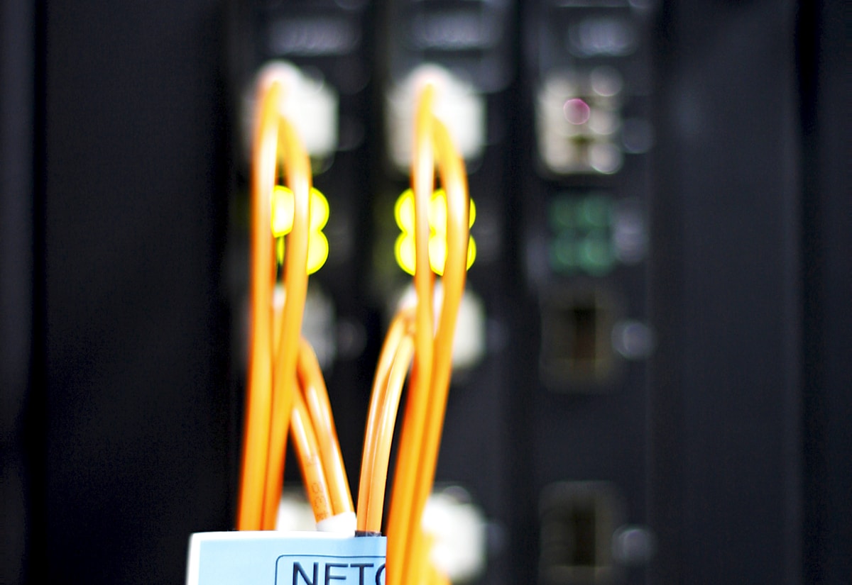 Fiber patch cords connected to a managed network switch